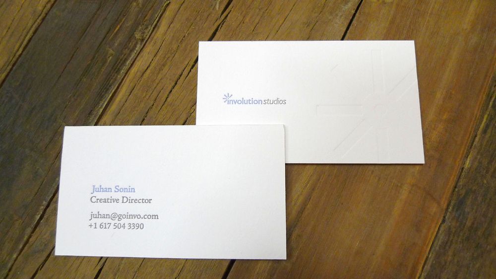 Letterpress-printed business cards on a wooden surface