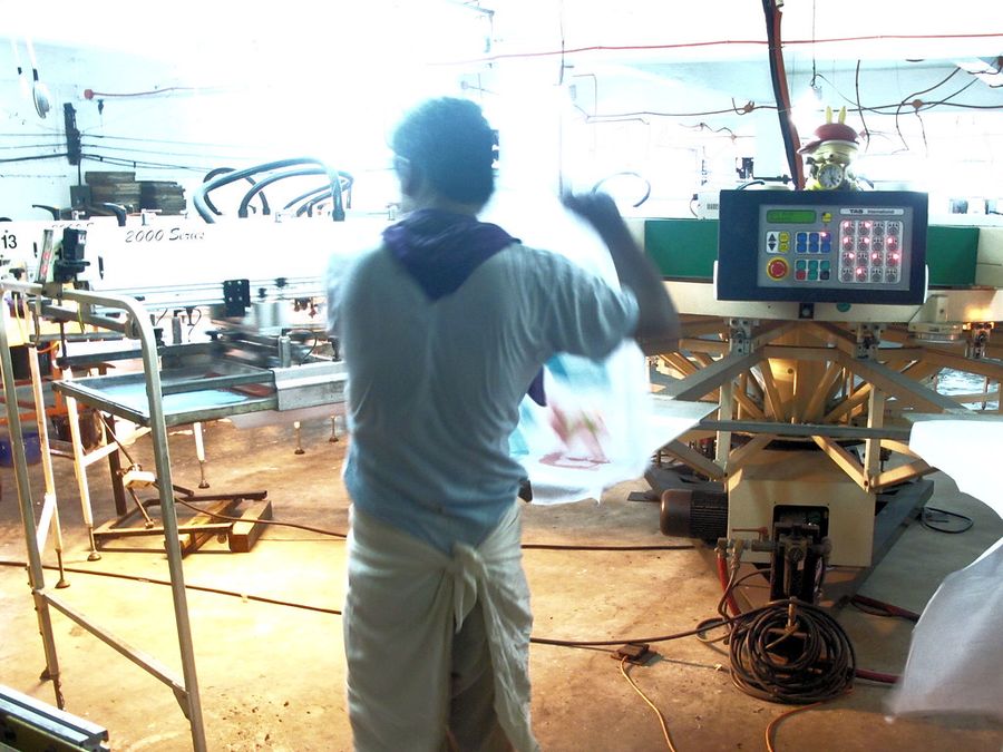 Printed garment coming off a screen-printing press