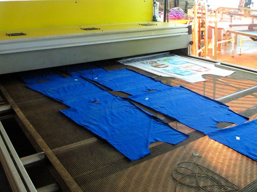 Freshly printed T-shirts on a drying conveyor